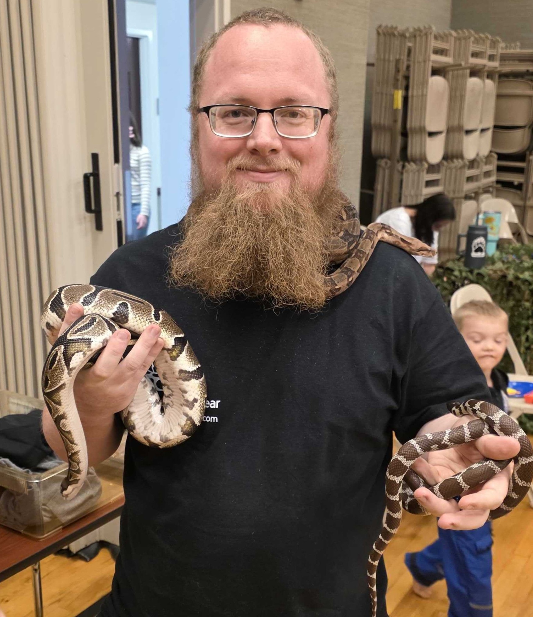 Reptile educator with a snake at a presentation